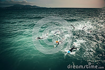 Triathlon swimmers train in open water Stock Photo