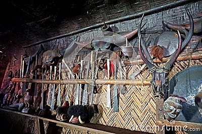 Various animal skulls and armory, decoration for longhouse, Longwa, Nagaland, India Stock Photo