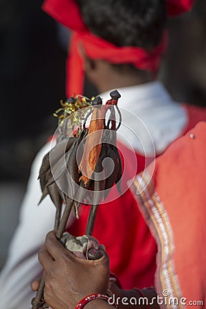 Tribal woman carryingtraditional Sticks with metalk accessaries during Dussera Procession near Jagdalpur,Chattisgarh,India Editorial Stock Photo