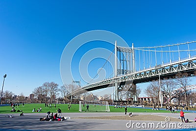 The Triborough Bridge and People Exercising around the Track and Field at Astoria Park Editorial Stock Photo