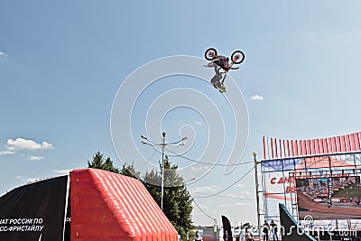 Tricks on a motorcycle jump performed by the athletes during the Editorial Stock Photo