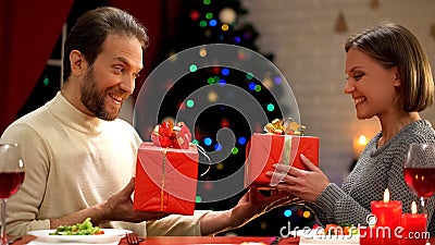 Tricky man giving fake Christmas present to woman, funny joke, sense of humor Stock Photo