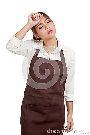 Tried Asian waitress in apron Stock Photo