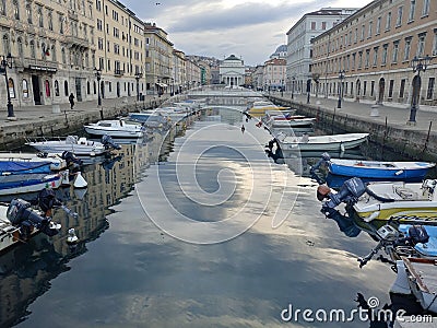 Trieste, Italy small boats in a river downtown Editorial Stock Photo