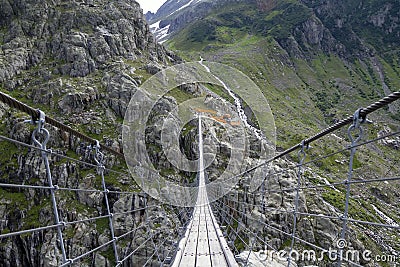 The Trift Bridge is one of the most impressive suspension pedestrian bridges in the Alps Stock Photo