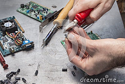 Trimming of the capacitor tip with pliers Stock Photo