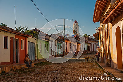 Trinidad, Cuba. The bell tower of San Francisco de Asis. Traditional local Cuban street with houses and the road is paved. Editorial Stock Photo
