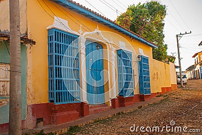 Trinidad, Cuba. Blue wooden grilles on Windows and doors. Local street in the old Cuban city. Editorial Stock Photo