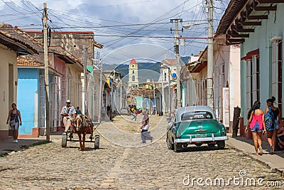 Trinidad, Cuba-November 15,2017. Street urban scene with old car and colorful Cuban houses.American classic car and lifestyle in Editorial Stock Photo