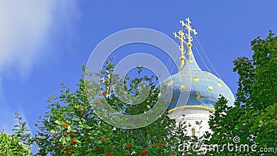 Trinity Sergius Lavra under blue sunny sky surrounded with ashberry trees Stock Photo