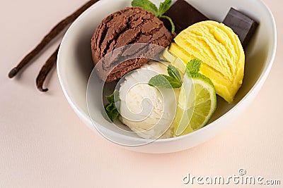 Trio of tasty chocolate vanilla and lime flavored frozen dessert in a white bowl. Stock Photo