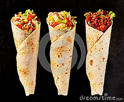 Trio of Tex Mex Fajita Wraps on Black Background Stock Photo