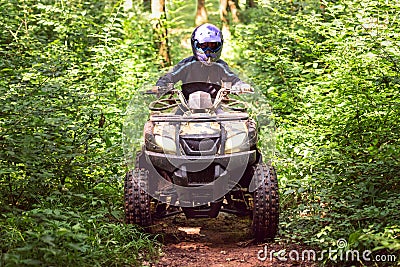 A trip on the ATV on the red road Stock Photo