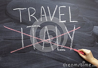 Trip to Italy. A woman`s hand crosses out the inscription Italy on a chalkboard. Cancellation of the tour due to the epidemic Stock Photo