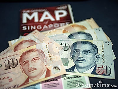 Trip to Singapore concept - Singapore dollar and map of Singapore Editorial Stock Photo