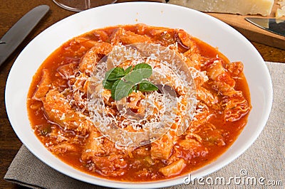 Tripe with tomato sauce called trippa alla romana, a typical dish from Lazio on wooden table Stock Photo