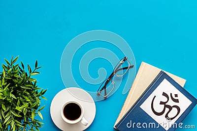 Tripitaka - Buddhist holy book near Om sign - on blue table top view copy space Stock Photo