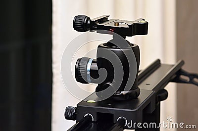 Tripod ball head mounted on camera slider Stock Photo