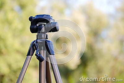 Tripod for camera stands on the street Stock Photo