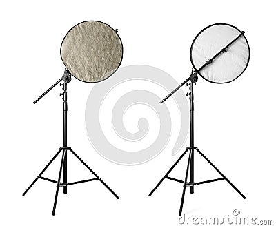 Tripods with reflectors on white background. Professional photographer`s equipment Stock Photo