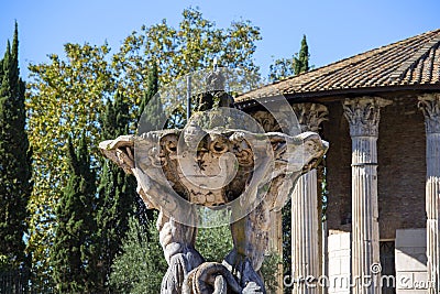 Tritons Fountain in front of the Temple of Hercules Victor in Square of the Mouth of Truth, Rome, Italy Stock Photo