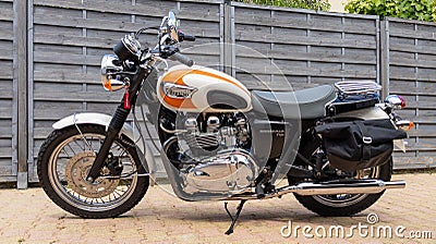 Triumph bonneville t100 bonnie carburetor white orange bike detail side with sign text Editorial Stock Photo