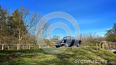 Triumph Herald 13/60 convertible parked by a bridge Editorial Stock Photo