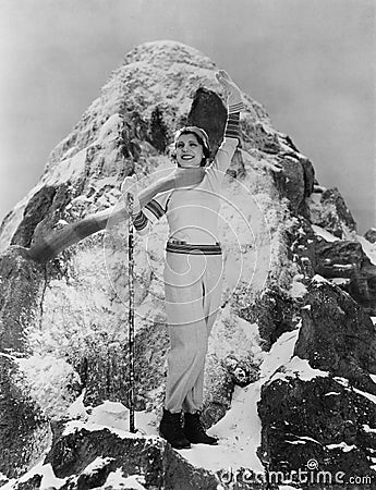Triumphant woman at mountain summit Stock Photo
