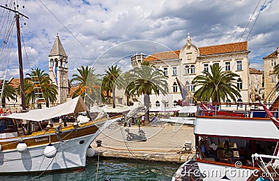 TROGIR, CROATIA sea promenade with an ancient building, palm and Editorial Stock Photo