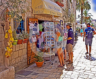 Trogir, Croatia - Tourists at souvenir shop on a warm sunny day Editorial Stock Photo