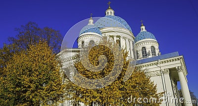 Troitsky Izmaylovsky cathedral with Autumn trees and blue sky background, in St. Petersburg, Russia Stock Photo