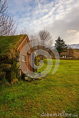 A Troll House In Iceland On A Green Meadow With Snowy Mountains In The Background Stock Photo