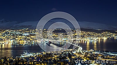 Tromso city night panorama, view from the mountains towards bridge and Arctic Cathedral Stock Photo