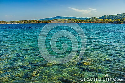 Tropic island idyllic picturesque landscape summer June day scenic view of sea bay shallow water foreground space and shore line Stock Photo