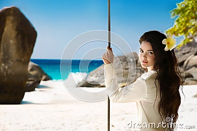 Tropical beach. Attractive smiling brunette girl summer portrait Stock Photo