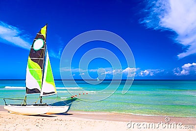 Tropical beach with a colorful sailboat on a summer day with turquoise water and blue sky. Varadero resort, Cuba Stock Photo