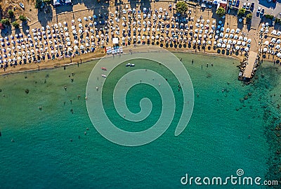 Tropical beach with colorful umbrellas - Top down aerial view. Lindos , Rhodes, Greece Stock Photo