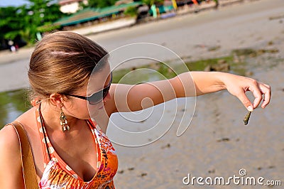 Tropical beach, finding a shell in Krabi, Thailand Stock Photo