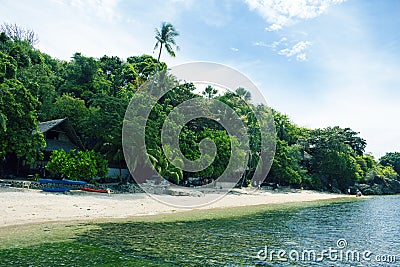 Tropical beach with green trees and white sand. Exotic island paradise toned photo. Stock Photo