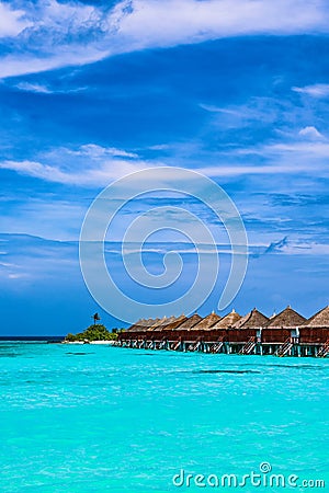 Tropical Beach and Overwater Bungalow Stock Photo