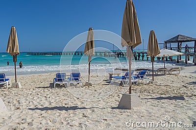 Tropical beach with sunbeds at the pier at Playa Caracol, Boulevard Kukulcan, Hotel Zone, Cancun Editorial Stock Photo