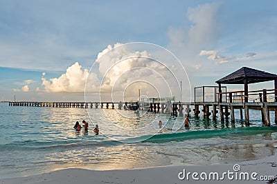 Tropical beach with tourists and pier Editorial Stock Photo
