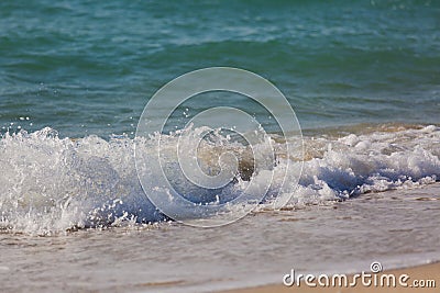 Tropical beach white sand, blue clear ocean water. sea foam on the beach on a sunny day. sea waves on the shore. surf breaking on Stock Photo