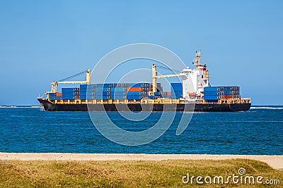 Tropical cargo ship Stock Photo