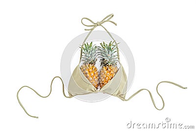 Tropical fashion concept. Pineapple fruit and swimwear on white background. Flat lay, top view. Stock Photo