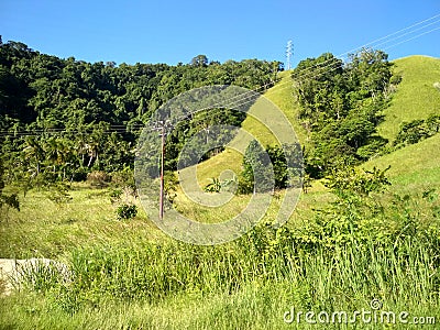 COMUNICATION WIRE IN GREEN SAVANA HILL PAPUA INDONESIA Stock Photo