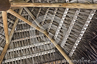 Tropical handmade coconut palm thatch roof for a beach kiosk in the summer Stock Photo