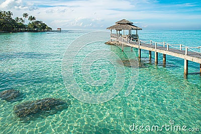 Tropical hut and wooden bridge at holiday resort. Summer travel Stock Photo