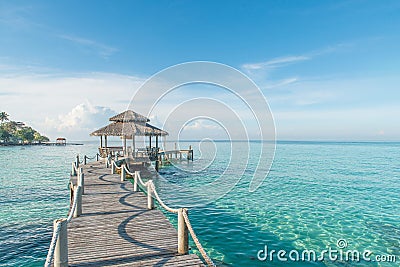 Tropical hut and wooden bridge at holiday resort. Summer travel Stock Photo