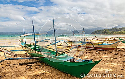 Tropical island landscape with bangca traditional philippines boats left at the shore, Puerto Princessa, Palawan Stock Photo